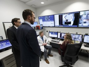 Radiation therapy students Chad Freeman (centre left) and Logan Veldman (right) give a tour of the University of Alberta's new radiation therapy training suite to Dr. Richard Fedorak (far left) and Minister of Advanced Education Marlin Schmidt at the Cross Cancer Institutre in Edmonton on Tuesday, February 21, 2017.