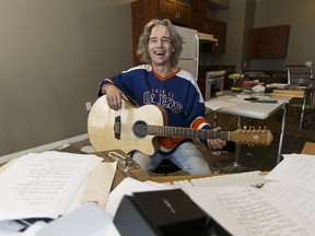 Rocko Vaugeois plays guitar in the subsidized unit he rents in Canora Place. Ian Kucerak/Postmedia