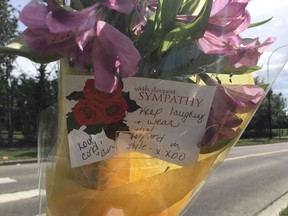Flowers left at a memorial for a 57-year-old woman killed on June 17, 2017 in a marked crosswalk on Suder Greens Drive between Lewis Estates Boulevard and Potter Greens Drive.