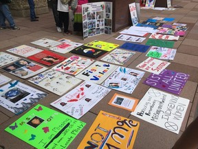 Signs demanding answers for missing and murdered indigenous women and girls, as well as men and boys, covered the steps of Edmonton City Hall before the Stolen Sisters and Brothers Awareness walk on June 11, 2017.