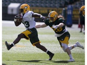 Jordan Hoover chases down Johnny Augustin during the Edmonton Eskimos intra-squad game on Friday June 2, 2017, in Edmonton.