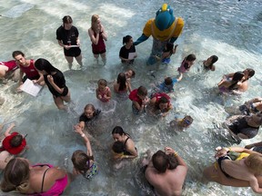People take part in a free swimming lesson at the West Edmonton World Waterpark as part of a larger attempt to set a Guinness World Record for the world's largest swimming lesson happening at the same time around the world on Thursday June 22, 2017. There were 26 participants at the Edmonton event.