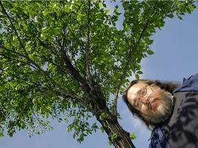 Mike Jenkins, a senior city biological sciences technologist, stands beside an elm tree infested with European elm scale on June 8, 2017.