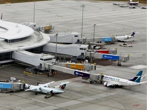 Air Canada and WestJet passenger jets are seen at gates at Edmonton International Airport (EIA) on Tuesday Oct, 1, 2013.