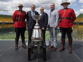 RCMP Cst. Jessica Brown, Jim Lawson, Chair of the Board of Governors of the Canadian Football League, Brad Sparrow, Chair, Board of Directors, Edmonton Eskimos, Edmonton Eskimos President and CEO, Len Rhodes and RCMP Cpl. David Brosinski pose with the Grey Cup on June 5, 2017, at Commonwealth Stadium after the Canadian Football League (CFL) announced that Edmonton will host the 2018 Grey Cup.