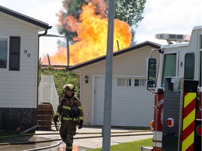 A fireball is visible as Stony Plain firefighters respond after a loud explosion was heard at Range Road 275 near 44 Avenue in Stony Plain, Alta., Thursday. A natural gas line erupted, police said.