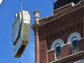 The old Molson sign is removed from atop the historic building known as the Molson Tower which operated as a brewery from 1913 to 2005 and is now being repurposed in Edmonton, June 1, 2017.