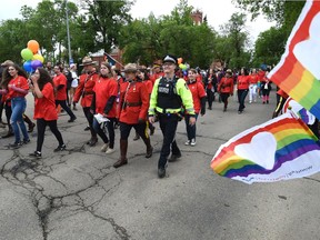 RCMP in red serge marching in the colourful annual Pride Parade which wound its way along Whyte Ave. to 104 St. in Edmonton, June 10, 2017.
