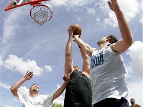 Todd Storm holds on to a rebound during an NBA 3 on 3 basketball tournament at the overflow parking lot north of West Edmonton Mall in 2008.