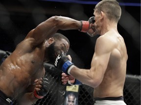 Tyron Woodley, left, hits Stephen Thompson in a welterweight championship mixed martial arts bout at UFC 209 on March 4, 2017, in Las Vegas.