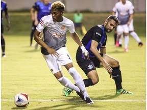 Puerto Rico FC midfielder Jorge Rivera, left, steps past FC Edmonton midfielder Adam Straith in North American Soccer League play at Juan Ramon Loubriel Stadium in Bayamon, Puerto Rico, on Saturday, June 3, 2017.