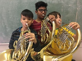 Three boys who will play the French horn with the Youth Orchestra of Northern Alberta for the first time when it joins with the Edmonton Symphony Orchestra to play June 13 are Khoan Nguyen, left, 11, Sehan Madurawala, 13, and Zander Ross, 10, students at St. Alphonsus Catholic School. The pubic is invited to reserve complimentary tickets to the performance.