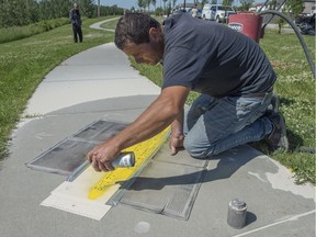 Vladimir Varbanov was sandblasting poetry into the sidewalks  bordering Mill Creek as part of a community art project in the Meadows on June 25, 2017. The poetry was submitted by school children and residents of the area.
