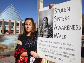 Walk founder April Eve Wiberg holds a sign during the Stolen Sisters Awareness Walk at City Hall in Edmonton, Alberta on Oct. 6, 2012. The 10th annual walk will be held outside City Hall Sunday amid questions about the national inquiry into missing and murdered indigenous women.