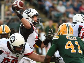 Ottawa Redblacks quarterback Trevor Harris (7) throws in traffic against the Edmonton Eskimos during CFL action at Commonwealth Stadium in Edmonton, July 14, 2017.