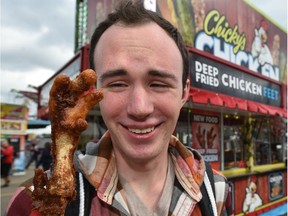 Reporter Dustin Cook tries deep-fried chicken feet at Chicky's Chicken, which was one of the entrants at the New Fair Food Contest at this year's K-Days in Edmonton, July 21, 2017.