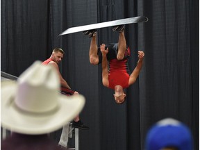 Trampolinist Sean Kennedy of Filppenout Productions putting on a trampoline performance wearing a snowboard at K-Days in Edmonton, July 22, 2017.