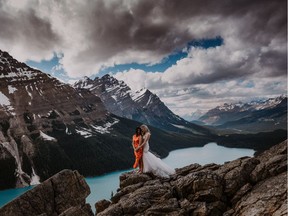 Suzanne Henry and Nicole Chu during their adventure photo session on the day after the wedding ceremony, on a ridge overlooking Peyto Lake in Banff National Park.