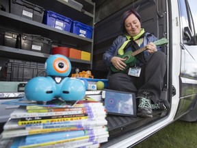 Library assistant Michelle Manke carries musical instruments, technology, and books inside one of the epl2go Literacy Vans, in Edmonton Wednesday June 21, 2017. Literacy vans are used in southwest quadrant communities of Rutherford, Allard, Callaghan and MacEwan.