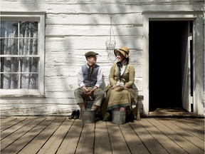 1885 Historical Interpreters Cedric Reimer and Keltie MacKenzie cool their heels in buckets of water at Fort Edmonton Park, in Edmonton on Thursday July 6, 2017.