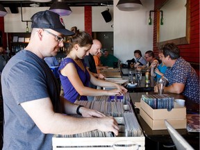People go through boxes of vinyl records during Dead Vinyl Society's Bring Out Your Dead record swap and sale at Daravara in Edmonton on Sunday, July 2, 2017.