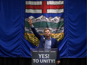 Wildrose leader Brian Jean waves to the crowd after the Wildrose party' voted to unite with the Progressive Conservatives, in Red Deer Saturday July 22, 2017.