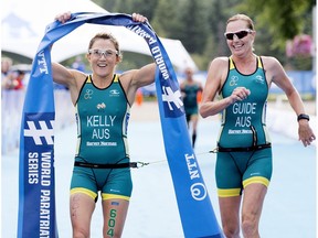 Australia's Katie Kelly celebrate's her win at the ITU World Triathlon Edmonton on July 28, 2017. Kelly is pictured with her guide Michellie Jones, right.