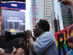 Transgender army veteran Tanya Walker speaks to protesters in Times Square near a military recruitment centre as they show their anger at President Donald Trump's decision to reinstate a ban on transgender individuals from serving in the military on July 26, 2017 in New York City. Trump citied the "tremendous medical costs and disruption" for his decision.