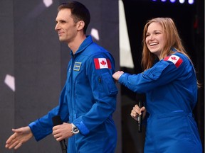 Canada's newest astronauts Joshua Kutryk and Jennifer Sidey acknowledge the crowd during Canada 150 celebrations on Parliament Hill in Ottawa on Saturday, July 1, 2017.