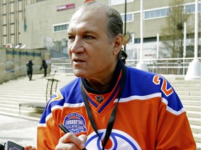 Former Edmonton Oilers enforcer Dave Semenko signs autographs at a public rally at Churchill Square in Edmonton on April 20, 2017.