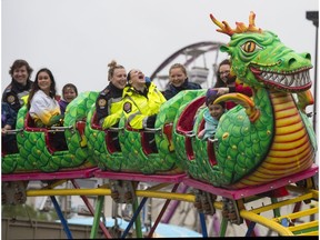 Kids and medics enjoy the Dragon ride at Monday Morning Magic at K-Days in Edmonton on July 24, 2017.