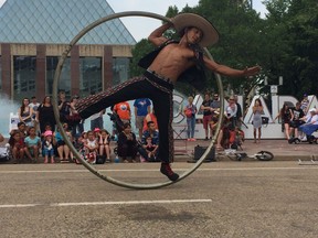 Francisco Sandoval (Pancho Libre) turns inside a Cyr wheel as part of his act in the Edmonton International Street Performers Festival 2017. Photo by Meghan Bunn