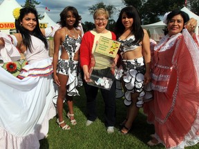 Edmonton Latin Festival Dancers Ingrid Torres, left, Lili Baly, Juana Lagua, and Isis Soldevala stand with Edmonton Food Bank executive director Marjorie Bencz,
centre, during the launch of the Edmonton Food Bank's food drive at the Heritage Festival, at Hawrelak Park in Edmonton, Alta. on Aug. 2, 2013. Heritage festival organizers are looking for more volunteers to assist the food bank Aug. 5 to 7.