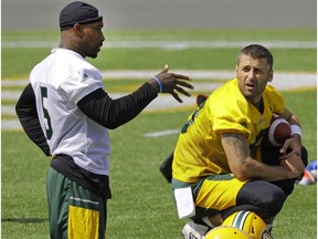 Edmonton Eskimos running back Travon Van (left) and quarterback Mike Reilly converse during team practice at Commonwealth Stadium in Edmonton on Monday July 10, 2017.