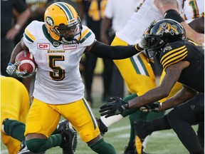 Edmonton Eskimos running back Travon Van (5) gives a straight arm to Hamilton Tiger-Cats defensive back Will Hill (1) during first half CFL football action in Hamilton, Ont., on Thursday, July 20, 2017. THE CANADIAN PRESS/Dave Chidley ORG XMIT: DJC108
Dave Chidley,