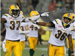 Edmonton Eskimos linebacker Kenny Ladler (37) celebrates with defensive back Arjen Colquhoun (36) after he intercepted a pass to end the game against the Hamilton Tiger-Cats during fourth quarter CFL football action in Hamilton, Ont., on Thursday, July 20, 2017.