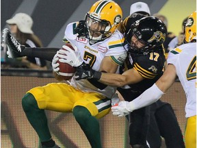 Edmonton Eskimos defensive back Josh Woodman (7) intercepts a pass intended for Hamilton Tiger-Cats wide receiver Luke Tasker (17) during fourth quarter CFL football action in Hamilton, Ont., on Thursday, July 20, 2017.