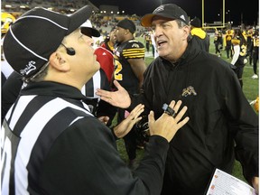 Hamilton Tiger-Cats head coach Kent Austin speaks with a referee following his team's loss to the Edmonton Eskimos during CFL football action in Hamilton on Friday, October 28, 2016.