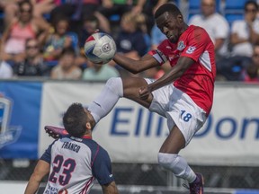 Tomi Ameobi of FC Edmonton, goes high to receive a pass despite Marco Franco of the Indy Eleven at Clarke Stadium kicking off the fall NASL season in Edmonton on July 29, 2017.