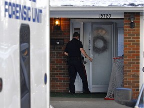 In a 2007 file photo, a police officer enters the Patricia Heights home where Kawliga Potts, 3, was beaten by his foster mother, Lily Choy. Potts later died of his injuries. Choy was convicted of manslaughter in 2011.