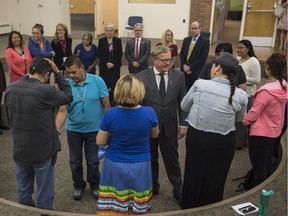 Education Minister David Eggen takes part in a smudge ceremony in an education building classroom. Eggen, announced a $665,000 grant to increase the number of Indigenous language instructors in the province on Tuesday, July 25, 2017.