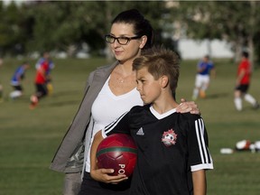 Jolanta Wandzel-Mrugala and her son Eric Mrugala, 10, pose for a photo at the soccer field in Henderson Park, 3408 Riverbed Road, in Edmonton on Monday July 17, 2017.