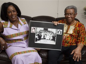 Agnes and Leo Sam, seen holding their wedding photo last month, moved with their 11-year-old daughter to Smoky Lake from Ghana in 1968.
