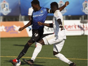 Edmonton's Tomi Ameobi (18) battles North Carolina's Christian Ibeagha (15) during a NASL soccer game between FC Edmonton and North Carolina FC at Clarke Stadium in Edmonton on Friday, July 7, 2017.