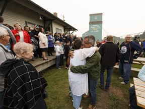 Daughter Stacey Worsfold (in white) hugs a supporter during a memorial for Ron Worsfold at the St. Albert Grain Elevator Park in St. Albert on Sunday, July 16, 2017. Worsfold was killed in a homicide.