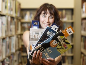 Raquel Mann, Edmonton Public Library's digital public spaces librarian, displays award-winning, popular books at the library's Enterprise Square branch in downtown Edmonton on Thursday, July 20, 2017.