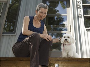 Mildred Thill, a registered dog sitter with the service Go Fetch, poses for a photo with Abbie at her home in Edmonton on Tuesday, July 25, 2017.