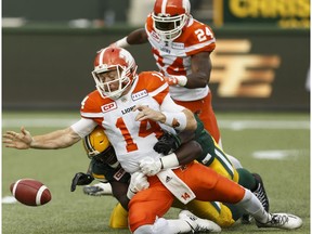 Edmonton's Kwaku Boateng (93) and Odell Willis (41) sack BC quarterback Travis Lulay during a CFL game between the Edmonton Eskimos and the BC Lions at Commonwealth Stadium in Edmonton on Friday, July 28, 2017.