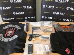 Weapons, ammunition, drugs and vests are displayed by the Alberta Law Enforcement Response Team during a press conference at the Wood Buffalo RCMP detachment in Fort McMurray, Alta. on Thursday, Feb. 23, 2017.