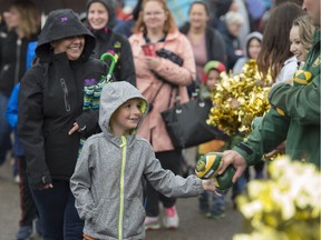 A participant at Monday Morning Magic gets a football from a representative of the Edmonton Eskimos. Monday Morning Magic is when when about 500 children between three and 12 years with special need are invited to K Days to enjoy the rides at their own pace, with local sports celebrities and professional athletes on July 24, 2017.  Photo by Shaughn Butts / Postmedia
Shaughn Butts, Postmedia